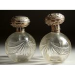 A PAIR OF SILVER TOP GLASS SCENT BOTTLES. London 1910.