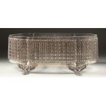 A CONTINENTAL SILVER MOUNTED GLASS JARDINIERE with period fretwork on four curving rose legs 12ins