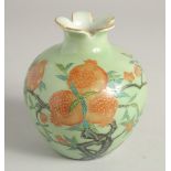 A SMALL GREEN GLAZE BULB VASE decorated with pomegranate blossom, six character mark to base. 12.5cm