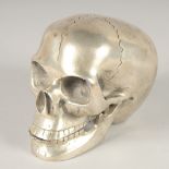 A SILVER PLATED SKULL with moving jaw. 3ins.