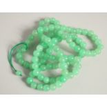 A STRING OF JADE BEADS 20ins long.