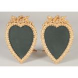 A GOOD PAIR OF GILT BRONZE HEART SHAPED EASEL PHOTOGRAPH FRAMES. 7ins x 4ins.