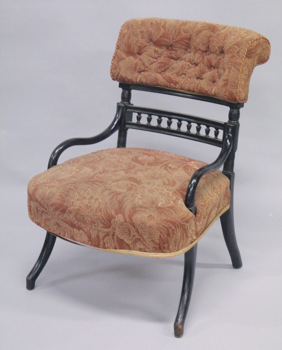 AN AESTHETIC MAHOGANY ARMCHAIR with black frame.