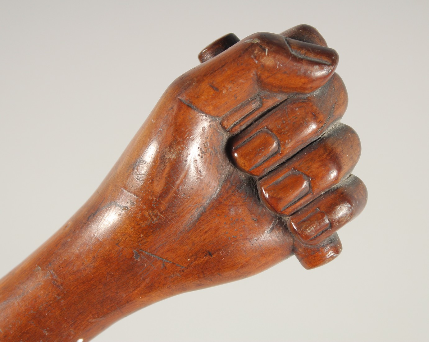 A FOLK ART WALKING STICK, 'Clenched Fist'. 36ins long.