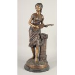 AFTER A MOIREAU. A LARGE BRONZE OF A GIRL playing a mandolin. 2ft 1ins high on a circular base.