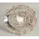 A VICTORIAN SILVER OVAL FRUIT BASKET with repousse decoration, on four bun feet. 11ins x 8ins.