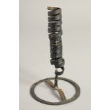 AN EARLY METAL CANDLESTICK. 7ins high.