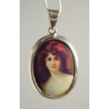 A SILVER AND ENAMEL GIRL PENDANT.