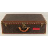 A LARGE LOUIS VUITTON SUITCASE. No. 981622. Label faded. Lock no. 1078192. 31.5ins long x 20.5ins