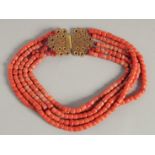 A FIVE ROW CORAL NECKLACE with filigree gold clasp.