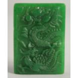 A CHINESE CARVED DRAGON JADE PENDANT. 2ins