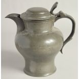 AN EARLY PEWTER ALE JUG AND COVER. 9ins high.