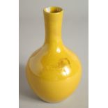 A CHINESE YELLOW PORCELAIN VASE. 7ins high.