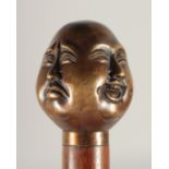 A FOUR-FACED BUDDHA'S HEAD WALKING STICK 3ft long