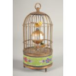 A SMALL MUSICAL BIRD CAGE CLOCK 6ins high.