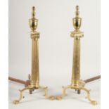 A PAIR OF BRASS COLUMN ANDIRONS. 2ft high.