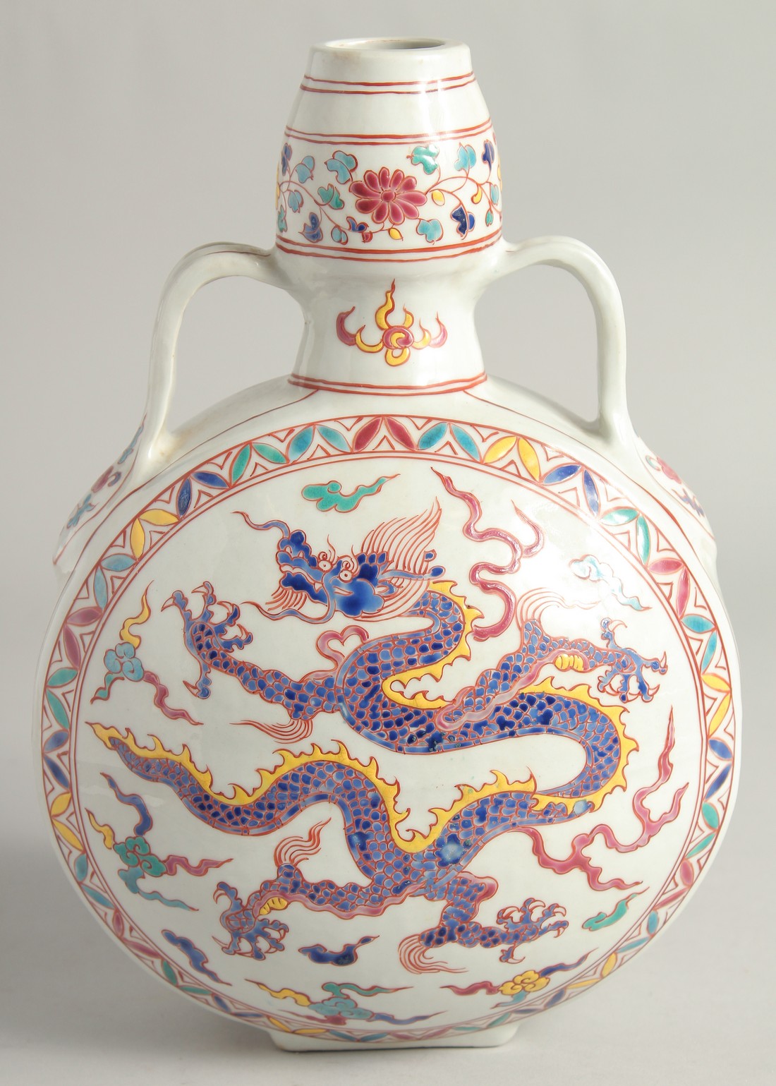 A CHINESE WUCAI PORCELAIN TWIN HANDLED MOON FLASK decorated with a central dragon. 29cm high.