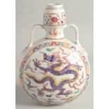 A CHINESE WUCAI PORCELAIN TWIN HANDLED MOON FLASK decorated with a central dragon. 29cm high.