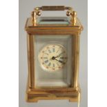 A MINIATURE BRASS CARRIAGE CLOCK 2ins high.