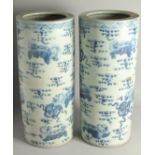 A GOOD PAIR OF CHINESE BLUE AND WHITE UMBRELLA STANDS.