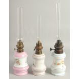 THREE FRENCH PORCELAIN OIL LAMPS AND GLASS FUNNELS.