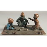 A VIENNA COLD CAST PAINTED GROUP OF THREE BOYS PLAYING DICE on a carpet. 8ins long.