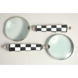 A PAIR OF MAGNIFYING GLASSES with chequered handles (2).