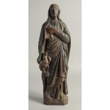 AN EARLY CARVED WOOD FLAT BACKED RELIGIOUS FIGURE. 19.5ins long.