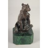 A SMALL BRONZE OF A BEAR. 5ins high on a marble base.