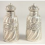 TWO VICTORIAN SILVER SCENT BOTTLES AND STOPPERS. 5ins high.