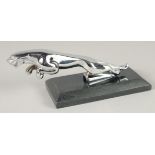 A CHROME JAGUAR CAR MASCOT on a marble base. 7ins long.