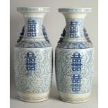 A TALL, PAIR OF CHINESE BLUE AND WHITE VASES. 1ft 11ins high.