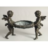 A GOOD 19TH CENTURY FRENCH SPELTER CENTREPIECE, a bowl held up by two cherubs.