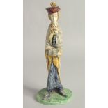 A MAJOLICA POTTERY CANDLESTICK FIGURE. 11ins high.