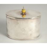 A REPRODUCTION SILVER PLATED OVAL TEA CADDY with pineapple final with crest.