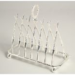 A SILVER PLATED SIX DIVISION TOAST RACK with cross guns,