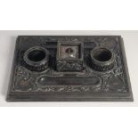 A FINELY CAREVD EARLY 19TH CENTURY SRI LANKAN CEYLANESE EBONY INK DESK STAND, with a central inset