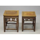 TWO GOOD CHINESE HARDWOOD SQUARE STANDS, each inset with a burr wood panel, above a carved frieze