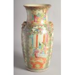 A CHINESE CANTON FAMILLE ROSE PORCELAIN VASE, with moulded twin handles and painted with panels of