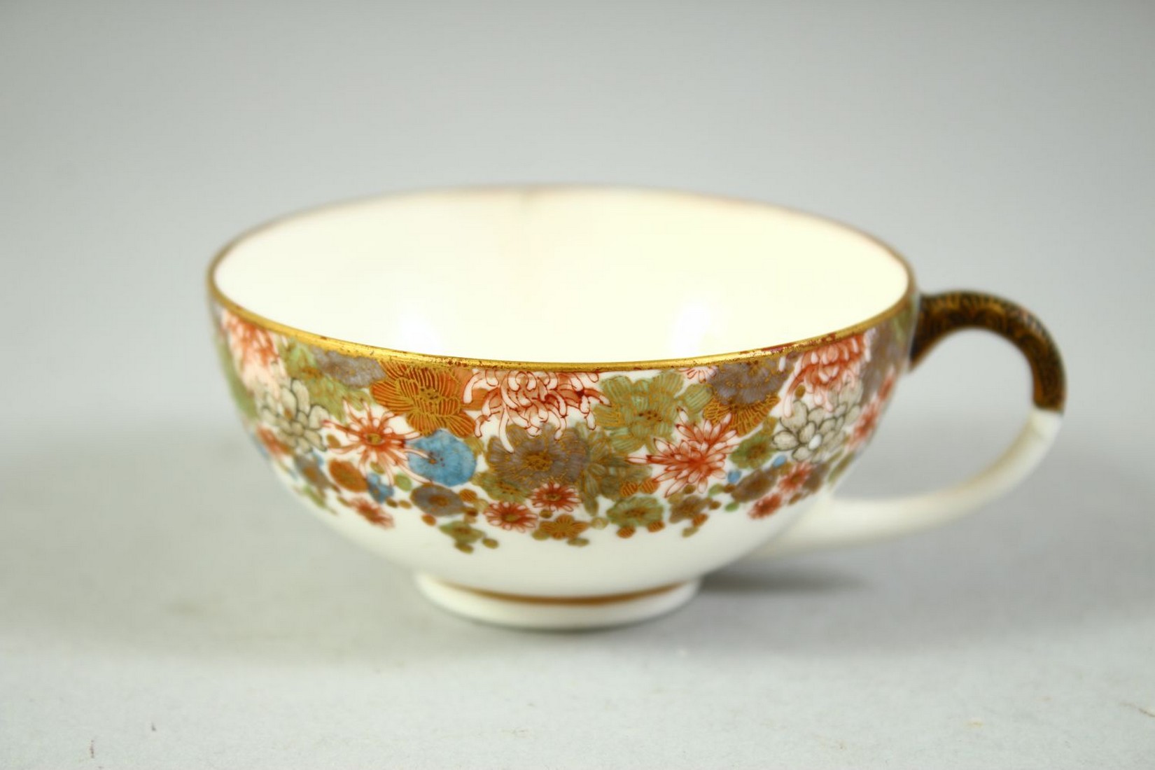 A SMALL JAPANESE SATSUMA CUP AND SAUCER, finely decorated with flowers and butterflies, each piece - Image 3 of 6