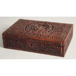 AN INDIAN CARVED WOOD BOX, with hinged lid, key included, 27.5cm x 18.5cm.