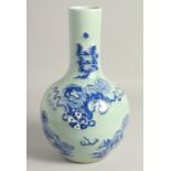 A CHINESE CELADON GROUND BLUE AND WHITE VASE, decorated with foo dogs, 35cm high.