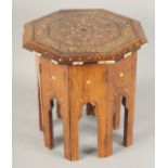 A SMALL MOORISH OCTAGONAL TABLE with folding base, with inlaid bone decoration, 31cm diameter,