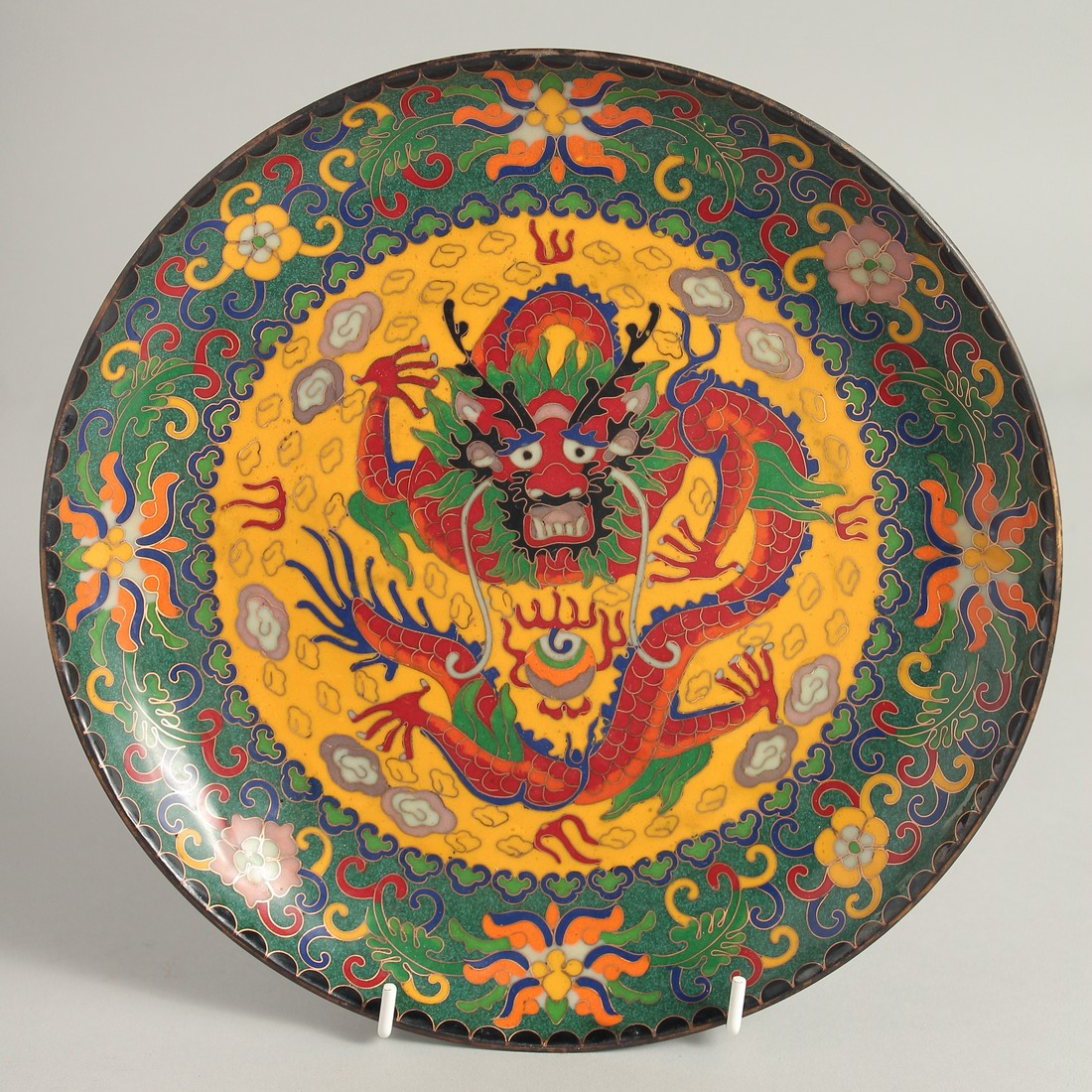 A CHINESE CIRCULAR BRONZE CLOISONNE DISH, the centre decorated with a dragon, with a border of
