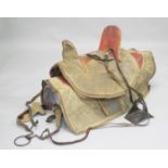 AN ARAB LEATHER SADDLE WITH EMBROIDERED COVER and matching under-blanket / cover, together with