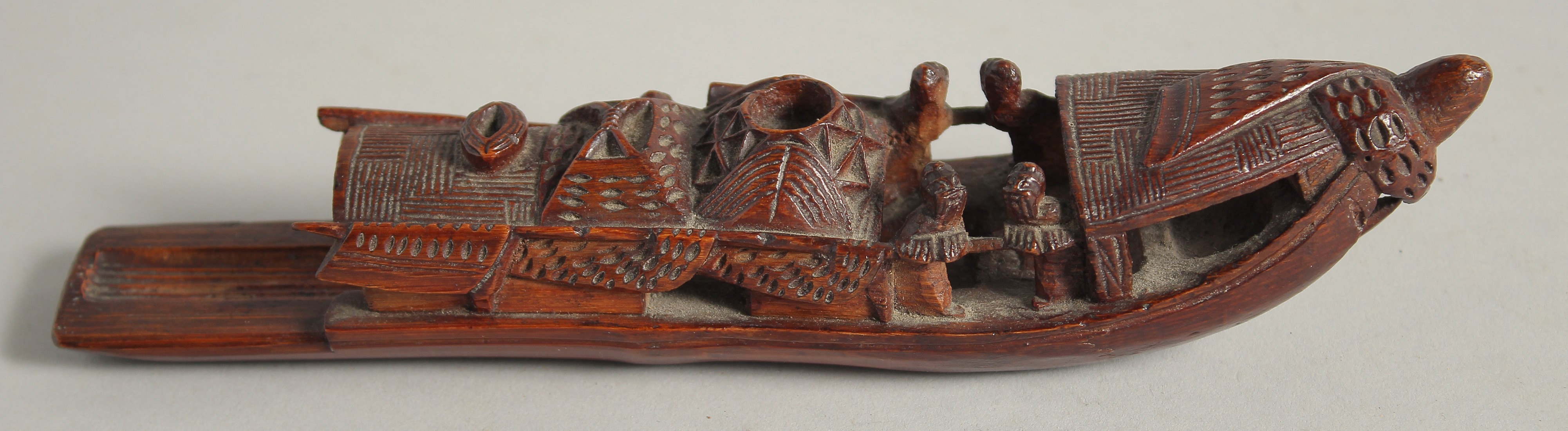 A CHINESE CARVED WOOD MODEL OF A BOAT, 22cm long.