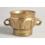 A 14TH/15TH CENTURY HISPANO MORESQUE BRASS MORTAR, with twin handles, 15cm wide (handle to handle).