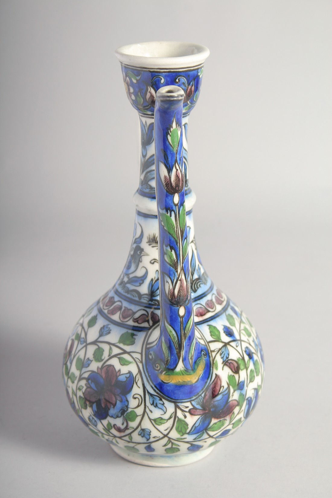 A 19TH CENTURY PERSIAN QAJAR GLAZED POTTERY EWER, painted with birds, flower heads, and scrolling - Image 2 of 6