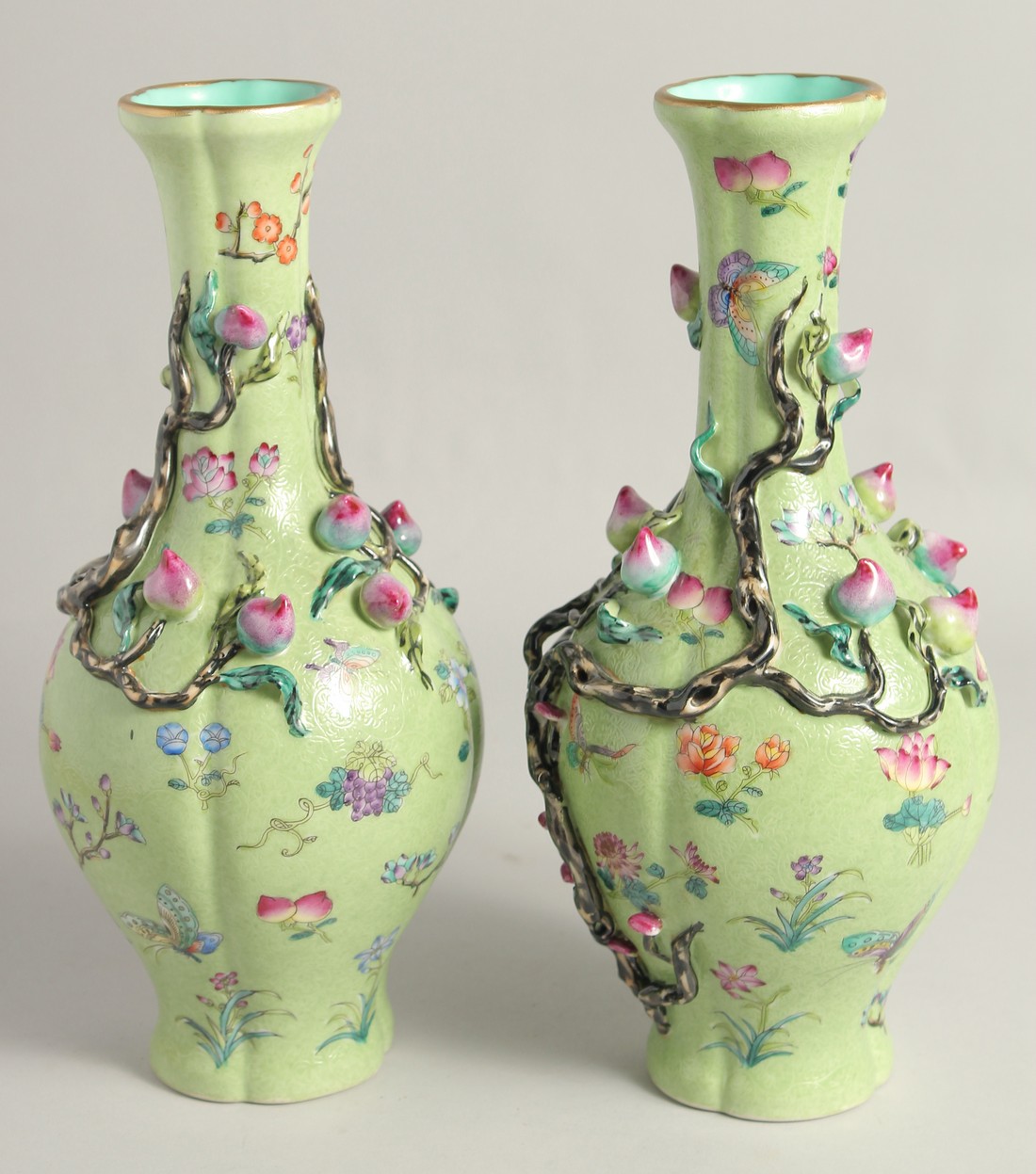 A PAIR OF CHINESE GREEN GROUND PORCELAIN VASES, with relief peach blossom and further decorated with - Image 3 of 8