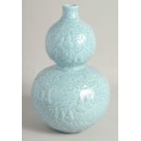 A CHINESE POWDER BLUE GLAZE DOUBLE GOURD VASE, with raised decoration all over depicting gourds